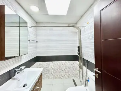 a bathroom with a shower and a toilet and a sink at Homes2Retreat - Glamz Haven Stylish Studio with Balcony in Dubai