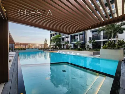 an infinity pool in a hotel with awning at Hamilton House, Jumeirah Village Circle in Dubai