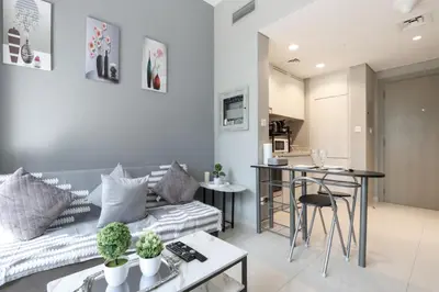 a living room with a couch and a table at Stylish 1BR Close to Metro Burj Khalifa & Dubai Canal in Dubai