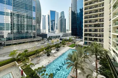 an overhead view of a pool in a city with tall buildings at Stylish 1BR Close to Metro Burj Khalifa & Dubai Canal in Dubai
