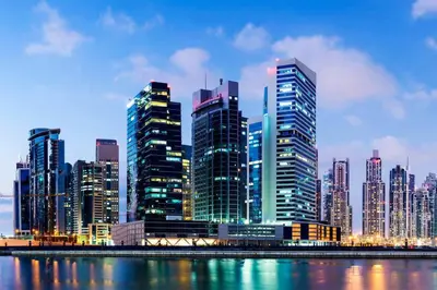 a city skyline with tall skyscrapers in a city at Stylish 1BR Close to Metro Burj Khalifa & Dubai Canal in Dubai