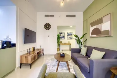 a living room with a purple couch and a table at Elegant Cozy Marina Home in Dubai