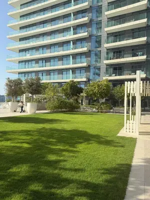 a large building with a lawn in front of a building at Blue Horizon Living in Dubai