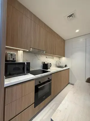 a kitchen with a sink and a microwave at Blue Horizon Living in Dubai