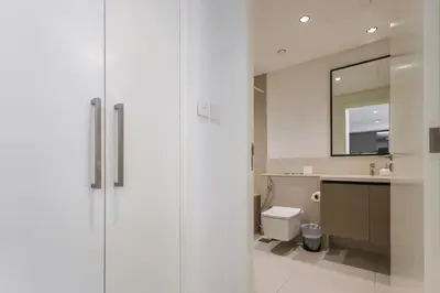a bathroom with a shower and a toilet and a sink at High-Rise & Boulevard View - 5-min to Burj & Mall in Dubai