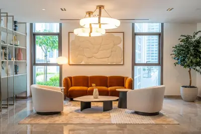 a living room with a couch and a table at High-Rise & Boulevard View - 5-min to Burj & Mall in Dubai