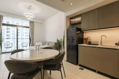 a kitchen and dining room with a table in a room at High-Rise & Boulevard View - 5-min to Burj & Mall in Dubai