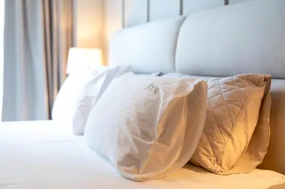 a white pillow sitting on top of a bed at Luxurious 1BR Pool with Burj Khalifa View Dubai Mall in Dubai