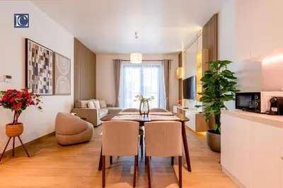 a kitchen and living room with a table and chairs at Luxury Escapes - Breathtaking 1BR with Sea View Port Lamer in Dubai