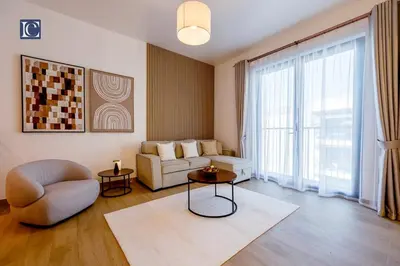 a living room with a couch and a chair at Luxury Escapes - Breathtaking 1BR with Sea View Port Lamer in Dubai
