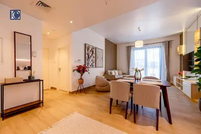 a dining room and living room with a table and chairs at Luxury Escapes - Breathtaking 1BR with Sea View Port Lamer in Dubai