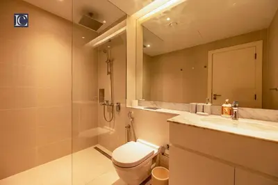 a bathroom with a toilet and a shower and a sink at Luxury Escapes - Breathtaking 1BR with Sea View Port Lamer in Dubai