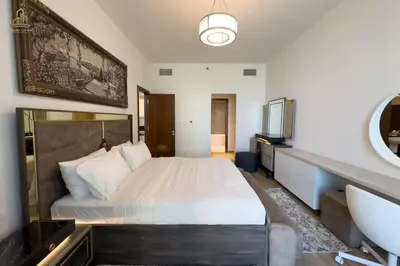 a bedroom with a large bed and a mirror at Stylish Canal Views Al Habtoor City in Dubai