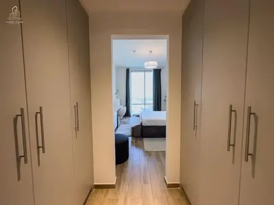 a room with cabinets and a bedroom with a bed at Stylish Canal Views Al Habtoor City in Dubai