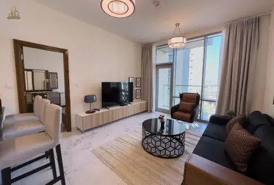 a living room with a couch and a tv at Stylish Canal Views Al Habtoor City in Dubai