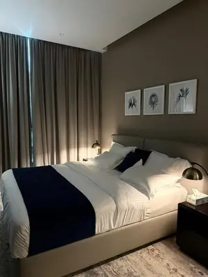 a bedroom with a large bed in front of a window at Damac Prive in Dubai