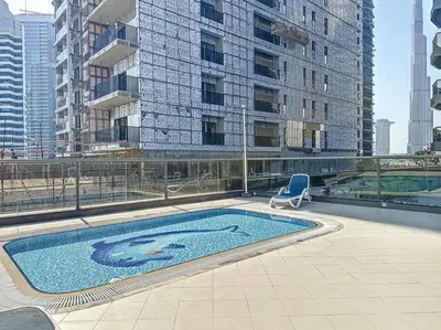 a swimming pool on the roof of a building at Stylish 1BR in Downtown Dubai in Dubai