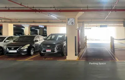 a parking garage with several cars parked in it at Stylish Lakefront Studio with King Bed and Balcony in Dubai