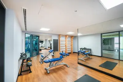 a gym with two treadmills and two exercise bikes at EasyGo-Marina Living with View and Amenities in Dubai