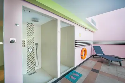 a bathroom with a shower and a bench at EasyGo-Marina Living with View and Amenities in Dubai