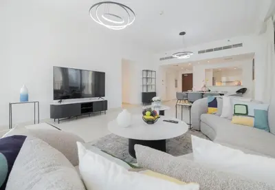a living room with two couches and a tv at Luxury 3BR Downtown Stay Near Burj in Dubai