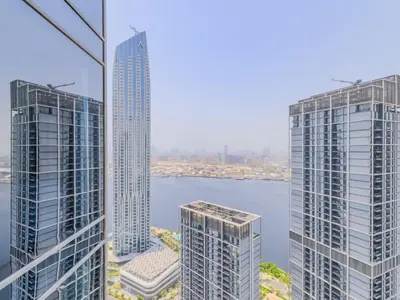 two tall buildings next to a body of water at TRPS - Creek Rise Tower, Dubai Creek Harbour - 3BR with Marina View in Dubai