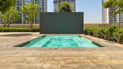 a swimming pool in the middle of a building at TRPS - Creek Rise Tower, Dubai Creek Harbour - 3BR with Marina View in Dubai