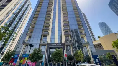 a tall building with a sign in front of it at TRPS - Creek Rise Tower, Dubai Creek Harbour - 3BR with Marina View in Dubai