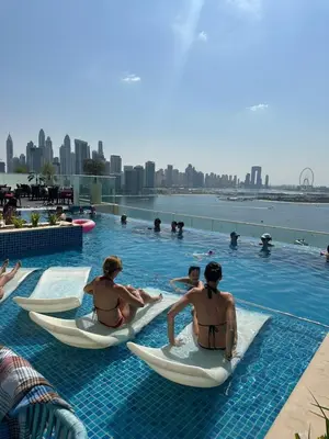 a group of people sitting in kayaks in a pool at Seven Palm Jumeirah Studio in Dubai