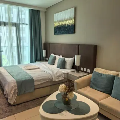 a bedroom with a large bed and a couch at Seven Palm Jumeirah Studio in Dubai