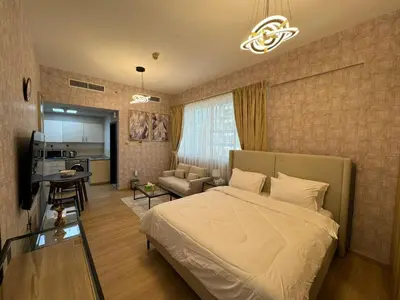 a bedroom with a bed and a living room at Champion Tower 1 Sports city By Al sarya Holiday Homes in Dubai