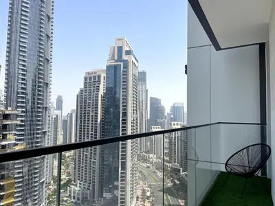 a chair sitting on the balcony of a building at Prestige stay next to Burj Khalifa in Dubai
