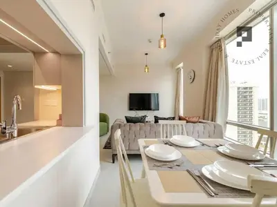 a kitchen and living room with a table and a couch at Cozy 1BR in Burj Views I Top Location Walk to Dubai Mall & Burj Khalifa I Wi-Fi in Dubai