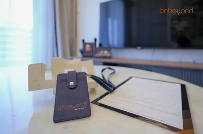 a table with a piece of paper and a clipboard at Bnbeyond's Canal Dreams and Luxe 2BR in Dubai