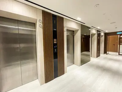 a row of elevator doors in a building at Brand New Studio In Tulip JVC in Dubai