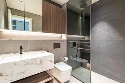 a bathroom with a sink and a toilet and a shower at SuperHost- Modern Studio in Arjan with pool & Gym in Dubai