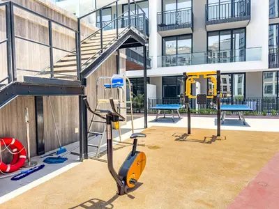 a playground in a building with a gym equipment at SuperHost- Modern Studio in Arjan with pool & Gym in Dubai