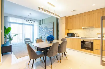a kitchen and dining room with a table and chairs at Sea View 2BR Apartment in Beach Vista 2 in Dubai