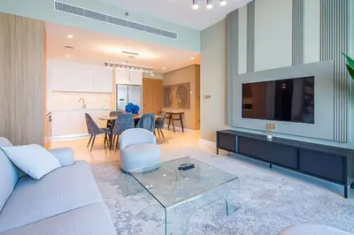 a living room with a couch and a tv at Sea View 2BR Apartment in Beach Vista 2 in Dubai