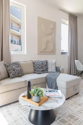 a living room with a couch and a coffee table at Cozy 1BR in the Peaceful Community of Motor City in Dubai