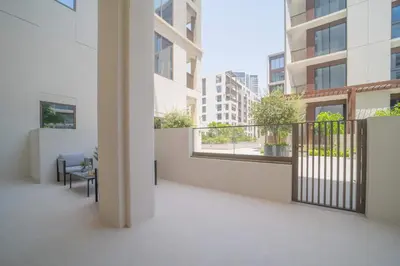 a balcony of a building with a table and chairs at Frank Porter - Groove at Creek Beach in Dubai