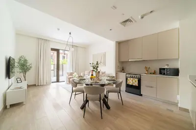 a kitchen and dining room with a table and chairs at Frank Porter - Groove at Creek Beach in Dubai
