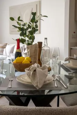 a glass table with a bowl of lemons on it at Frank Porter - Groove at Creek Beach in Dubai
