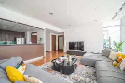 a living room with a couch and a table at Lavish 2BR - Study with Spacious Balcony in DIFC in Dubai