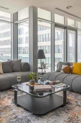a living room with a couch and a coffee table at Lavish 2BR - Study with Spacious Balcony in DIFC in Dubai