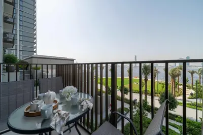 a balcony with a table and a view of the ocean at Frank Porter - Creek Crescent Tower 1 in Dubai