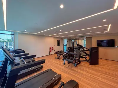 a gym with treadmills and exercise equipment in a building at Frank Porter - Creek Crescent Tower 1 in Dubai