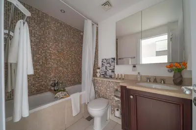 a bathroom with a tub and a toilet and a sink at Frank Porter - Zaafaran 4, Old town, Downtown Dubai in Dubai