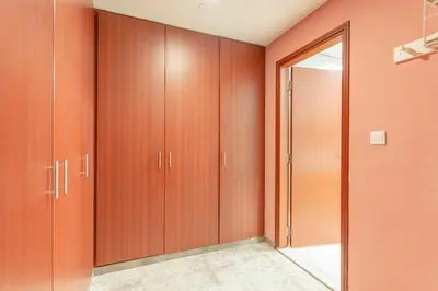 a room with wooden cabinets and a mirror at Seashell stunning 2 bedrooms in JBR in Dubai