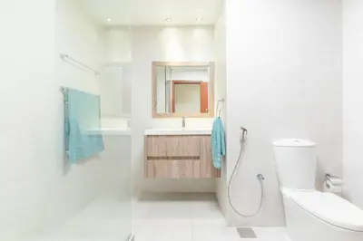 a white bathroom with a sink and a toilet at Seashell stunning 2 bedrooms in JBR in Dubai